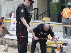A child suffered a cut when someone through an object at a vehicle, smashing the window. Above, police are pictured investigating the incident at 200 Wellesley St. E. (Veronica Henri, Toronto Sun)