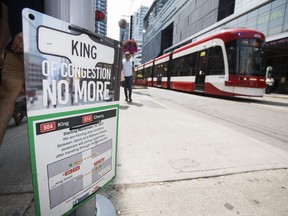 A sign informs TTC riders that streetcars will not stop at a transit shelter along King St. W. at John St.  on July 9, 2019. (Ernest Doroszuk, Toronto Sun)