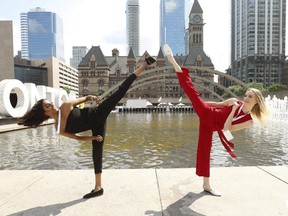 Miss World Canada 2019 contestants Andrea Jerom, of Toronto (L), and Victoria Berndt, of Georgetown, do some kung fu high kicks at Nathan Phillips Square on July 24, 2019. (Jack Boland, Toronto Sun)