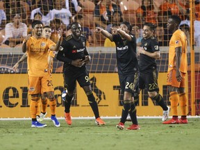 Los Angeles FC forward Adama Diomande (left) celebrates with teammates after scoring a goal during the second half against the Houston Dynamo at BBVA Stadium. (USA TODAY SPORTS)