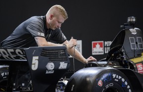 A mechanic works on Canadian race car driver James Hinchcliffe’s car ahead of the Honda Indy in Toronto, on Thursday, July 11, 2019. (Andrew Lahodynskyj/The Canadian Press)