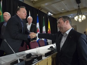 Alberta Premier Jason Kenney shakes hands with Quebec Premier Francois Legault following a closing news conference at a meeting of Canada's Premiers in Saskatoon, Sask. Thursday, July 11, 2019. THE CANADIAN PRESS/Jonathan Hayward