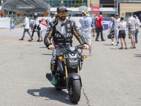 Canadian James Hinchcliffe drives a scooter to his car before qualifying at the Honda Indy Toronto yesterday. Hinchcliffe will start in the 14th spot today.  Mark Blinch/The Canadian Press