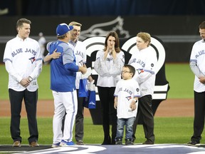 John Gibbons greets Brandi Halladay, the widow of former Blue Jays ace Roy Halladay, and his two sons in a ceremony on Opening Day in 2018. (GETTY IMAGES)