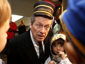Toronto Mayor John Tory hands out candies to kids from the City Hall daycare centre in this Toronto Sun file photo.
