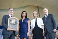 A member of the hall of fame committee holds the Hall of Fame plaque for 2019 inductee Roy Halladay, along with Brandy Halladay, widow of Roy, and baseball hall of fame chairman of the board Jane Forbes Clark and Baseball Commissioner Rob Manfred on Sunday. (USA TODAY SPORTS)