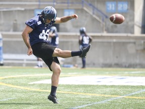 Toronto Argonauts' Zack Medeiros punts during a practice session. (JACK BOLAND/Toronto Sun)