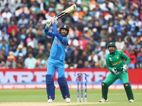 India's Yuvraj Singh hits to the offside as wicketkeeper Sarfraz Ahmed looks on. (GETTY IMAGES)