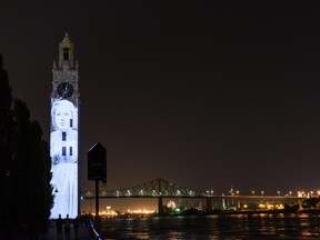 A video is projected on the Clock Tower near the Jacques Cartier Bridge in the Old Port of Montreal. (Tourism Montreal photo)