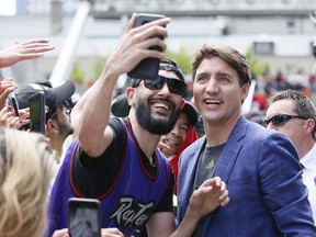 Canadian prime minister Justin Trudeau poses for a selfie with a Toronto Raptors fan during a rally at Toronto city hall Nathan Phillips Square.
