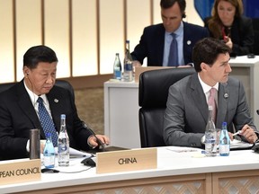 China's President Xi Jinping (L) and Prime Minister Justin Trudeau attend the session on women's workforce participation, future of work, and ageing societies, at the G20 Summit in Osaka, Japan,  June 29, 2019. Kazuhiro Nogi/Pool via REUTERS