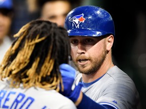 Toronto Blue Jays first baseman Justin Smoak (14) pulls the hair of left fielder Lourdes Gurriel Jr. (13)  after hitting a solo home run against the Boston Red Sox during the sixth inning at Fenway Park on Tuesday.  Brian Fluharty-USA TODAY