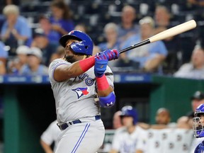 Toronto Blue Jays third baseman Vladimir Guerrero (27) hits a grand slam against the Kansas City Royals during the ninth inning at Kauffman Stadium on Tuesday night. Jay Biggerstaff-USA TODAY Sports