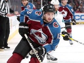 Alexander Kerfoot #13 of the Colorado Avalanche advances the puck against the San Jose Sharks at the Pepsi Center on January 18, 2018 in Denver, Colorado.  (Photo by Matthew Stockman/Getty Images)