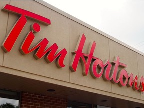 In this file photo taken on August 27, 2014 the sign over a Tim Hortons coffee-and-donut shop is viewed in Magog, Quebec.