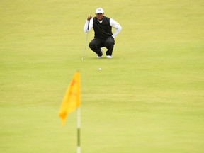 US golfer Tiger Woods lines up a putt on the 18th hole after the second round of the British Open golf Championships at Royal Portrush golf club in Northern Ireland on July 19, 2019.