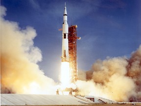 The Apollo 11 Saturn V space vehicle lifts off July 16, 1969, with astronauts Neil A. Armstrong, Michael Collins, and Edwin E. Aldrin aboard.  )