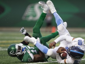 Saskatchewan Roughriders safety Mike Edem (left) and Argonauts quarterback James Franklin tumble to the ground during 
the second half in Regina on Monday night. Toronto lost in lopsided fashion for a second consecutive week. (THE CANADIAN PRESS)