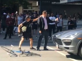 A cyclist and a driver are seen in an alleged road-rage incident July 4, 2019. (Reddit)