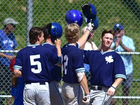 In the middle of this throng of Maple Leafs is Greg Carrington, who’d just slugged a grand slam in the sixth inning to solidify a 10-2 win over Welland yesterday.  Bryan Passifiume/Toronto Sun