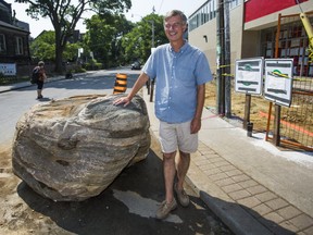 Brian Burchell, chair of the Bloor Annex BIA, stands next to a 2,000 kilogram granite boulder, estimated to be 1.2 to 1.5 billions years old, at the corner of Major and Bloor Sts. in the Annex neighbourhood in Toronto, Ont. on Friday, July 26, 2019. The old rock was dug up as a part of the construction of a new BIA sponsored parkette. (Ernest Doroszuk/Toronto Sun/Postmedia Network)