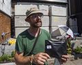 Medical cannabis user and customer of CAFE dispensary on Harbord St. Kevin Busch, holds product in his hand, despite the front of the shop being blocked by a wall of concrete blocks in Toronto, Ont. on Saturday July 20, 2019.