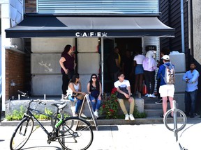 Concrete blocks sit in front of the newly re-opened Harbord St. CAFE cannabis dispensary on Thursday after owners managed to move enough of the 2,000 kg. barriers to regain access to the recently shut-down business.