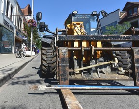 Pry bars sit in the forks of a hired telecarrier forklift outside the CAFE pot shop on Bloor St. W. on Thursday, July 18 2019
