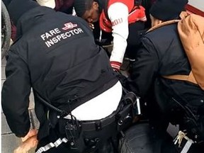 TTC fare inspectors detain a black man in February 2018. (Screengrab)
