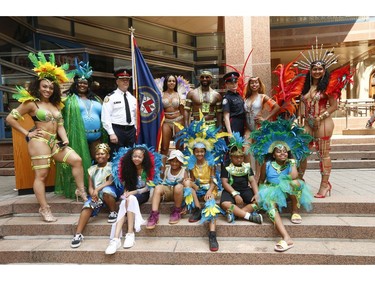 Toronto Police Supt. David Rydzik (L) and Const. Isabelle (R) Cotton with members of the Toronto Revellers mas camp held there Caribbean Carnival kick-off 2019 in preparation for the parade on August 3rd weekend on Friday July 26, 2019. Jack Boland/Toronto Sun/Postmedia Network