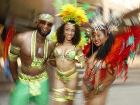 Toronto Revellers masqueraders Paul Anthony Perez, Mahogany Brown and Melissa Sobers were at Toronto Police Headquarters there Caribbean Carnival kick-off on August 3rd weekend on Friday, July 26, 2019. (Jack Boland/Toronto Sun/Postmedia Network)