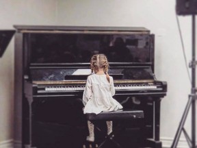 A girl from the CCAC is seen playing the piano. The CCAC was recently  hit by thieves who allegedly stole all the instruments and musical equipment ,putting the music program in jeopardy.