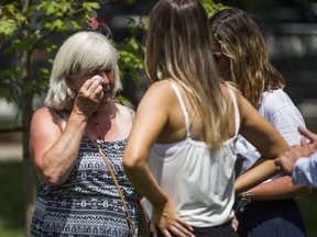 Sheryl Fallon, aunt of Reese Fallon who was killed in the Danforth shooting, wipes as tear she is joined by friends and family as they arrive for a  ceremony remembering those killed and injured during the July 22, 2018 shooting on Danforth Ave held at Withrow Park  on Sunday July 21, 2019. Ernest Doroszuk/Toronto Sun/Postmedia
