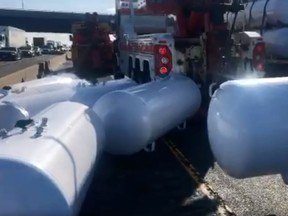 Propane tanks are seen on Hwy. 401 at Mississauga Road on Tuesday, July 16, 2019 after coming off a tractor trailer.