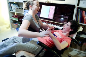 Alex Simmons (L) shares a laugh with her sister Emmy in their former home in Mississauga in this 2013 file photo. (Veronica Henri/Toronto Sun/Postmedia Network)