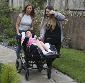Emmy Simmons, now 28, is seen here with support staff in Wales where her family now lives on Tuesday, July 2, 2019. (Veronica Henri/Toronto Sun/Postmedia Network)