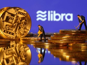 Small toy figures are seen on representations of virtual currency in front of the Libra logo in this illustration picture, June 21, 2019. (REUTERS/Dado Ruvic/Illustration/File Photo)