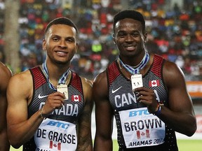 Andre De Grasse and Aaron Brown celebrate on the podium after placing first in the Men's 4x200 Metres Relay Final during the IAAF/BTC World Relays Bahamas 2017 at Thomas Robinson Stadium on April 23, 2017 in Nassau, Bahamas.  (Patrick Smith/Getty Images for IAAF)