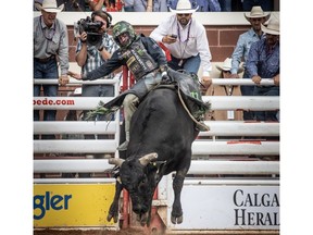 Chase Outlaw scored a 90 on Rhythm and Blues in Bull Riding at the Calgary Stampede Rodeo in Calgary, Ab., on Monday July 8, 2019. Mike Drew/Postmedia