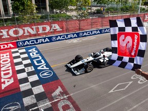 Simon Pagenaud of France crosses the finish line to win the 2019 Honda Indy Toronto, in Toronto, Sunday July 14, 2019.