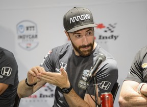 Oakville native James Hinchcliffe pretends to take down track notes from last year’s winner Scott Dixon during a media event at the Honda Indy in Toronto, on Thursday, July 11, 2019. (Andrew Lahodynskyj/The Canadian Press