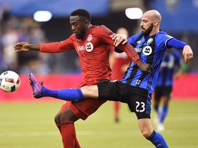 TFC forward Jozy Altidore (left) battles for the ball with then Impact defender Laurent Ciman in 2016. Climan is now a member of the Reds. (THE CANADIAN PRESS FILES)