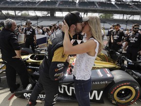 Canadian IndyCar driver James Hinchcliffe gets a kiss from Becky Dalton during the 2017 Indianapolis 500. 
They will get married in a few weeks. (AP PHOTO)