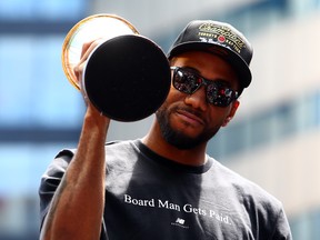 Kawhi Leonard holds the MVP trophy after leading the Toronto Raptors to the NBA title. Leonard has yet to decide where he will play next season. (Photo by Vaughn Ridley/Getty Images)
