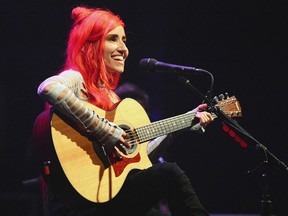 Lights with her guitar in hand singing "Drive My Soul" at the Danforth Music Hall on Saturday, July 27, 2019.