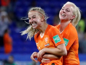 Netherlands' Jackie Groenen (left) and Inessa Kaagman (right) celebrate their victory over Sweden in the FIFA Women's World Cup semifinal in Lyon, France, on Wednesday, July 3, 2019.