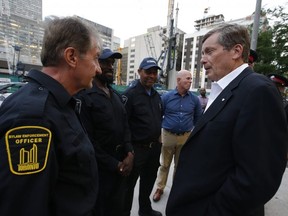 Toronto Mayor John Tory, right, at Toronto Fire Station 312 with police and bylaw inspectors speaking about the city's plan to deal with noise complaints on July 15, 2019. Jack Boland/Toronto Sun