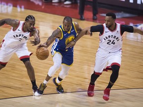 Former Raptor Kawhi Leonard (left) and Norman Powell (right) defend against former Warriors Andre Iguodala during Game 5 of the NBA Finals in Toronto last month. Powell says his opinion of Leonard hasn’t changed since the superstar left Toronto to sign with the Los Angeles Clippers. (THE CANADIAN PRESS)