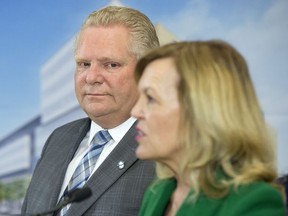 Ontario Premier Doug Ford watches as Health Minister Christine Elliott speaks at an event at The Centre for Addiction and Mental Health in Toronto on January 30, 2019. Ontarians are set to learn the government's plans today for an overhaul of the health-care system. Health Minister Christine Elliott is set to introduce legislation this afternoon and will make an announcement on it this morning.