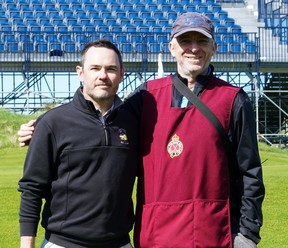 Jon McCarthy, left, poses with his caddie at Royal Portrush.